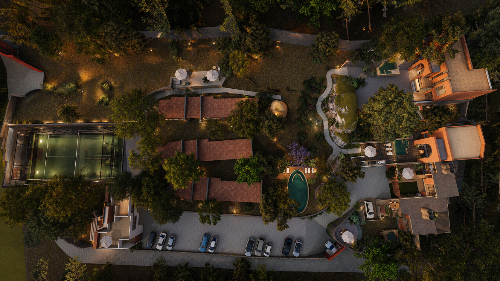 Vista aérea nocturna del conjunto Tierra Viva — cinco casas, jardines, alberca y cancha de pádel en Tierra Blanca, Tepoztlán